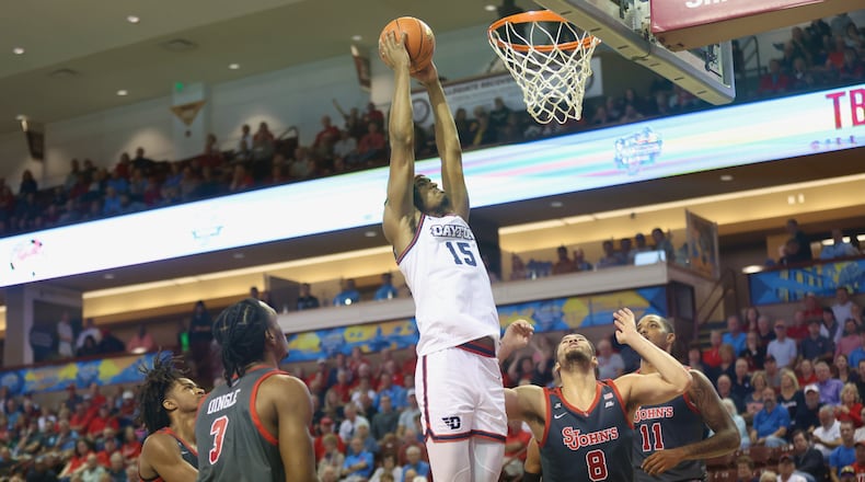 Dayton's DaRon Holmes II dunks against St. John’s in the semifinals of the Charleston Classic on Friday, Nov. 17, 2023, at TD Arena in Charleston, S.C. David Jablonski/Staff