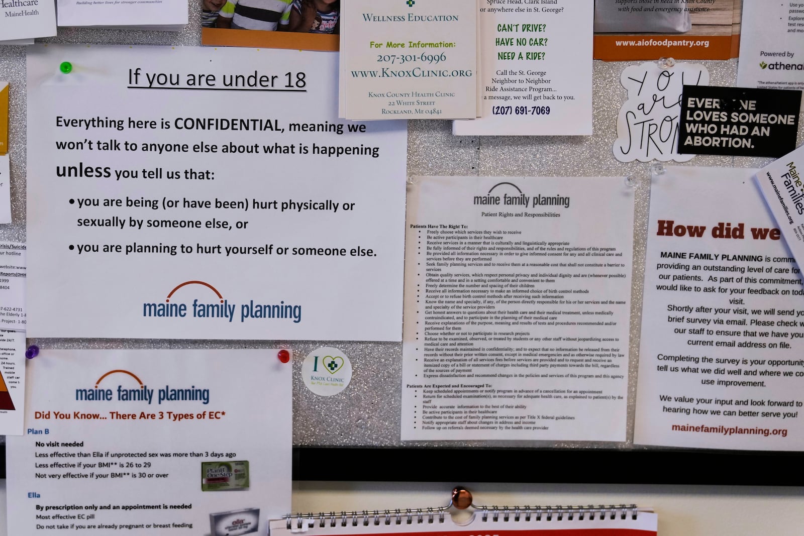 Flyers and documents are posted on a patient bulletin board in an examination room at the Maine Family Planning healthcare facility, July 15, 2025, in Thomaston, Maine. (AP Photo/Charles Krupa)
