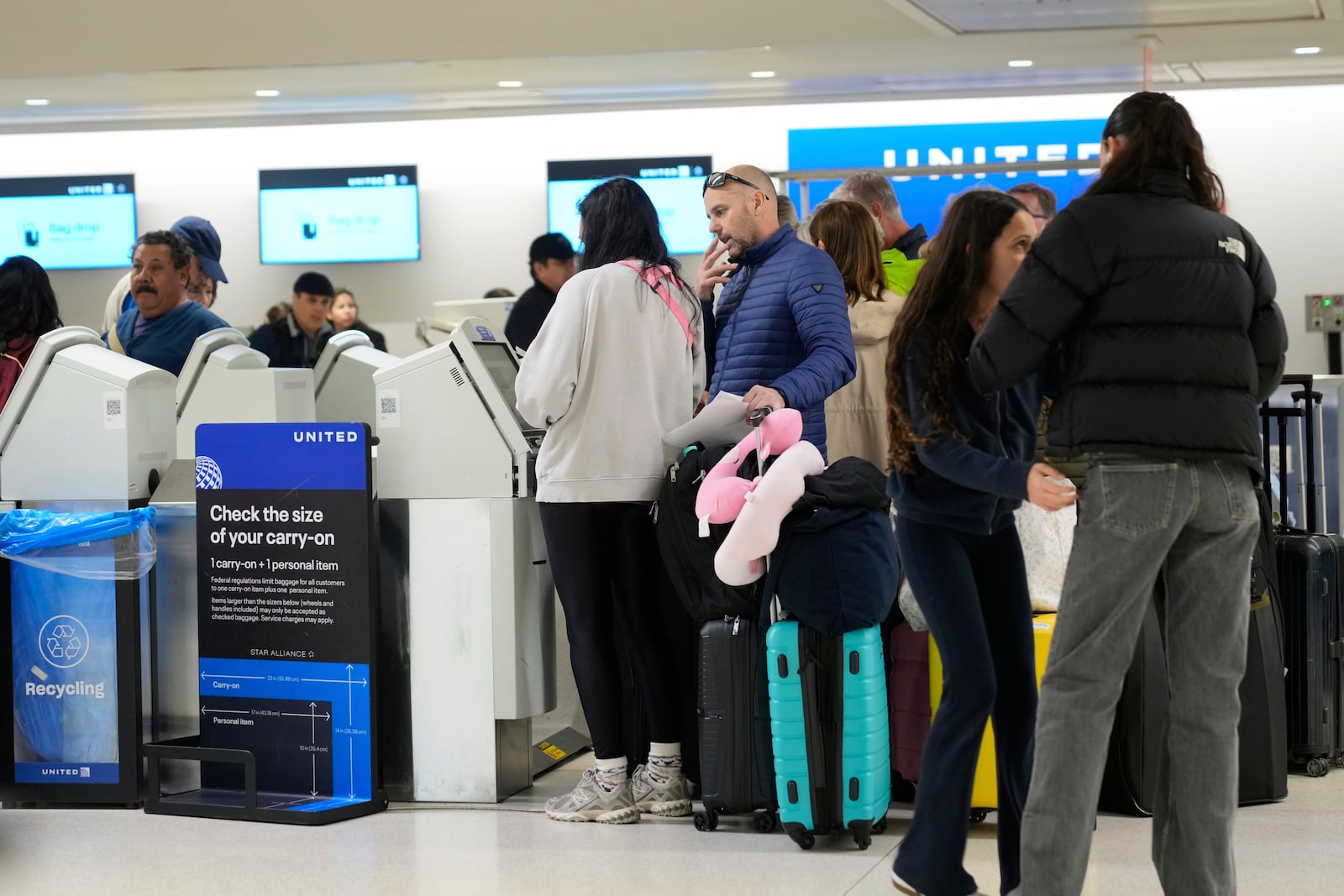 Travelers check into their flights at Newark Liberty International Airport in Newark, N.J., Monday, May 5, 2025. (AP Photo/Seth Wenig)