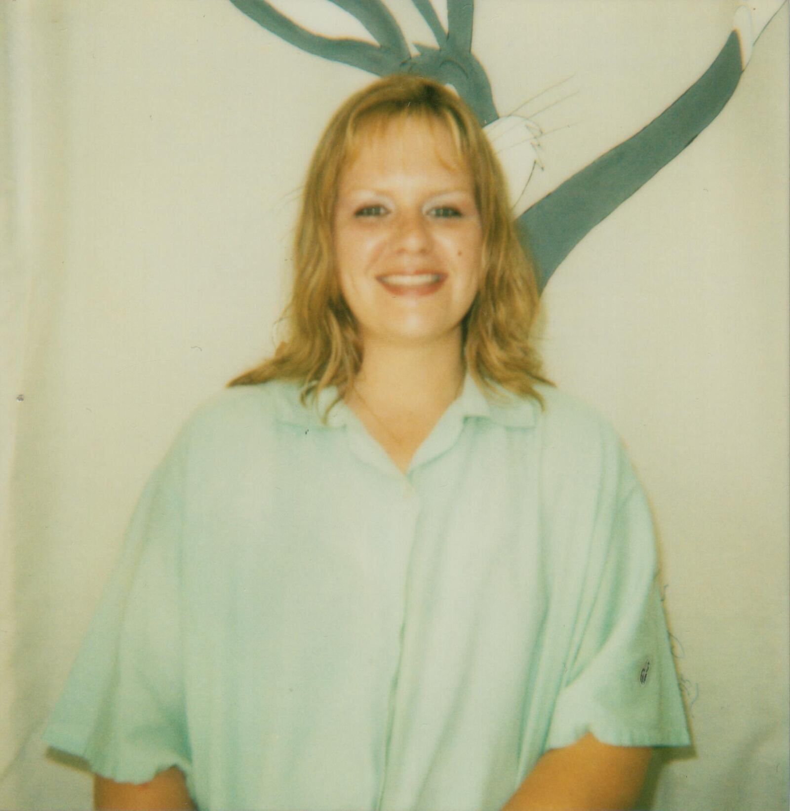Rebecca Hopfer alone, standing in front of Bugs Bunny mural
