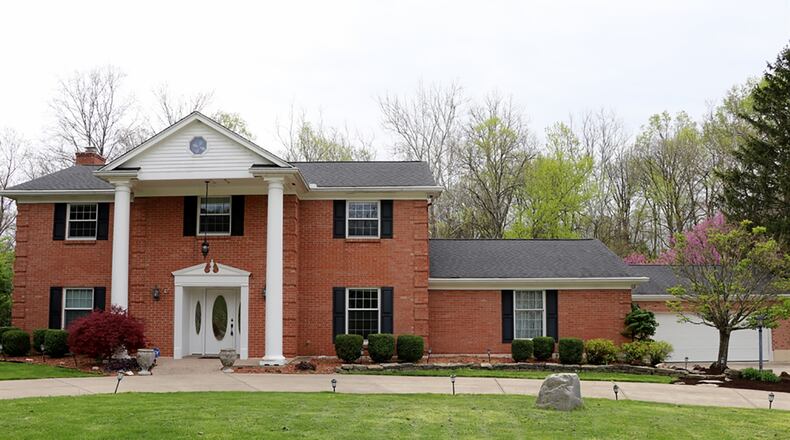 The brick 2-story has about 3,080 sq. ft. of living space. The 1.64-acre property includes a 2-car, detached garage and a 2-car, attached garage. A circular driveway branches off the driveway to the garages. CONTRIBUTED PHOTO BY KATHY TYLER
