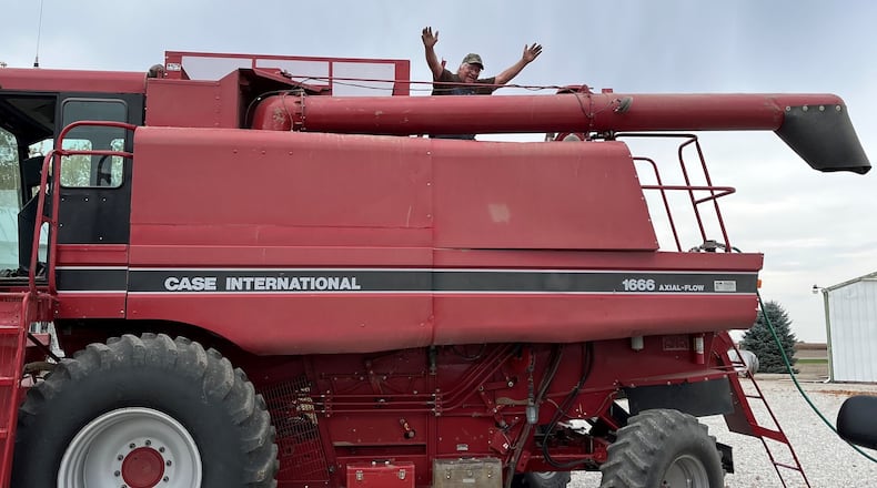 Darke County farmer Terry Warner celebrates his last day of farming from a top his combine. Contributed.