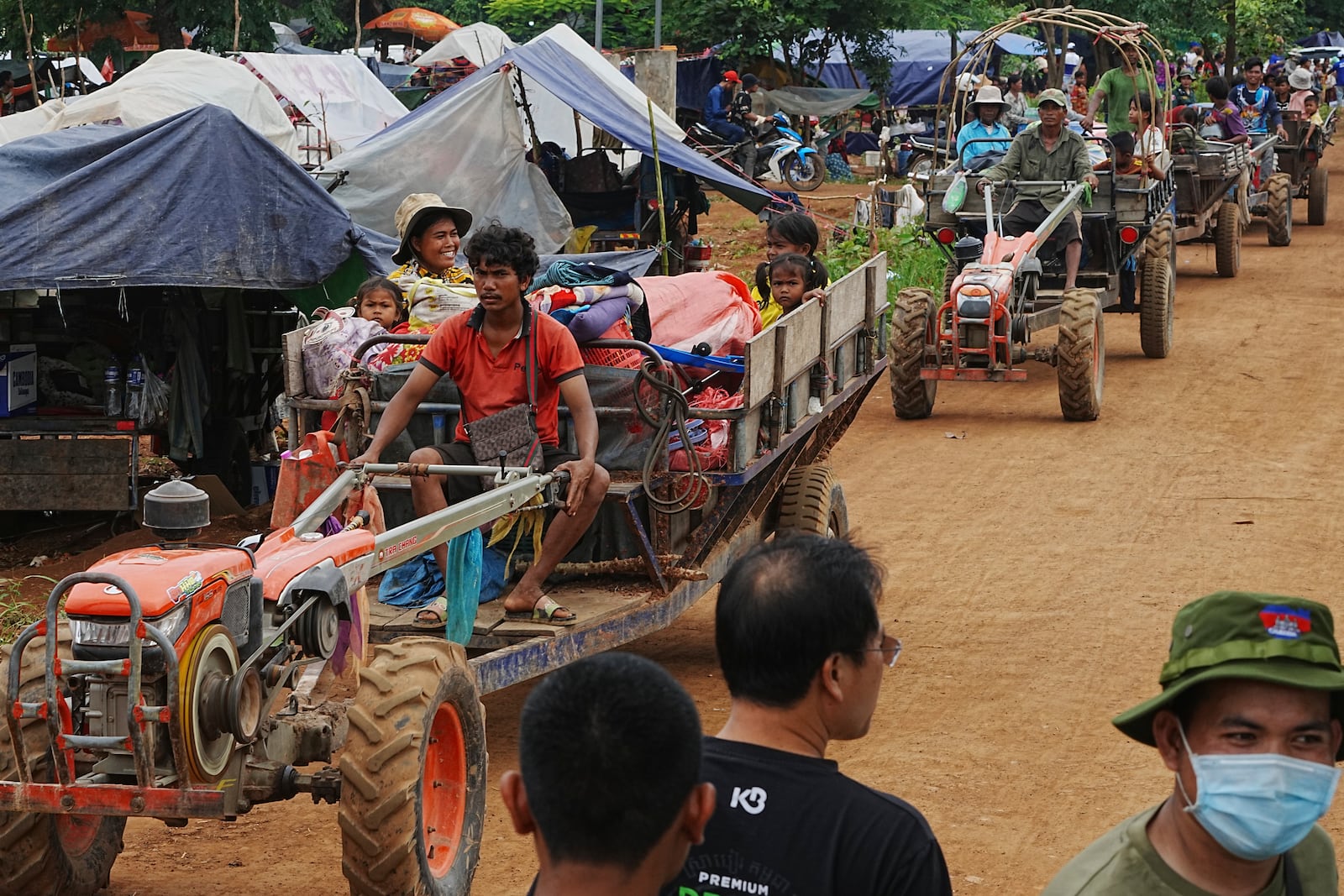 Cambodians sit on a cart of tractor as they take refuge in Batthkoa primary school in Oddar Meanchey province, Cambodia, Saturday, July 26, 2025, as border fighting between Thailand and Cambodia entered its third day. (AP Photo/Heng Sinith)