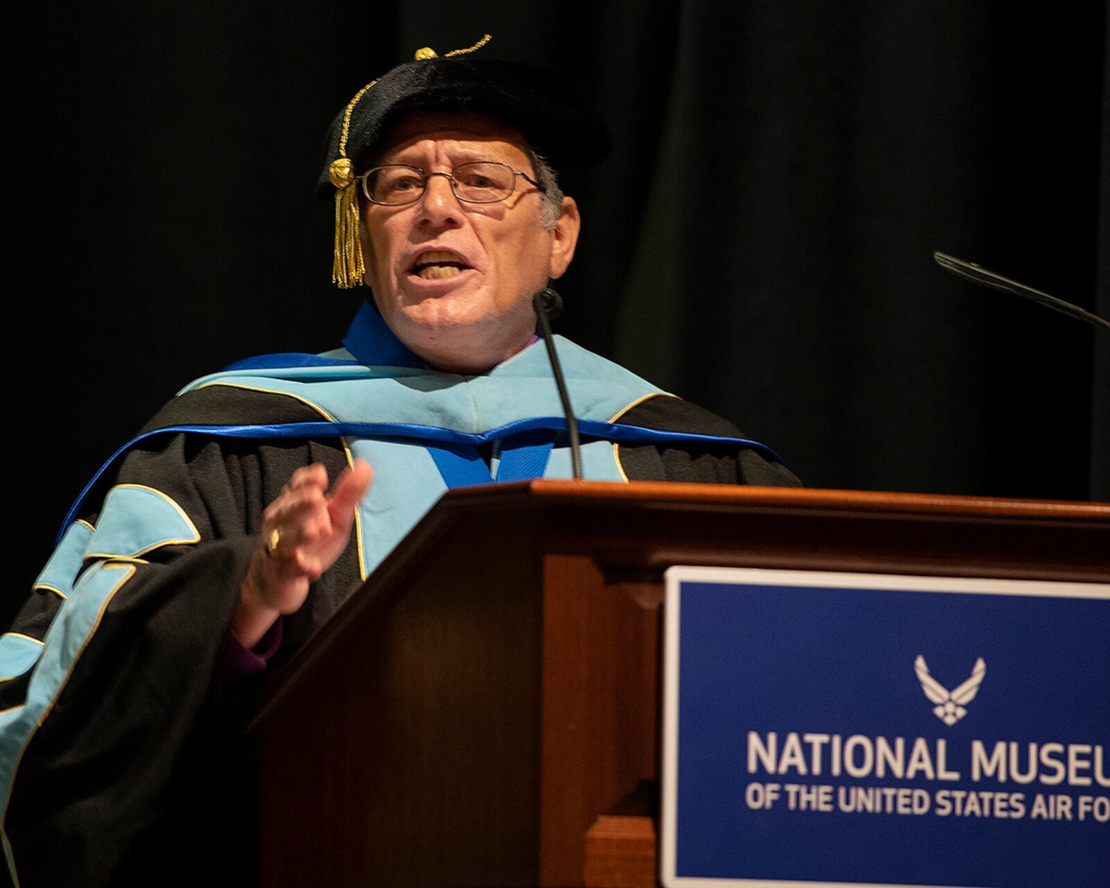 Donald Ellwood, Community College of the Air Force Education Services director, officially confers the degrees on the 40 Airmen graduating in the CCAF Wright-Patterson Spring 2022 commencement ceremony June 15 at the National Museum of the Air Force. U.S. AIR FORCE PHOTO/R.J. ORIEZ