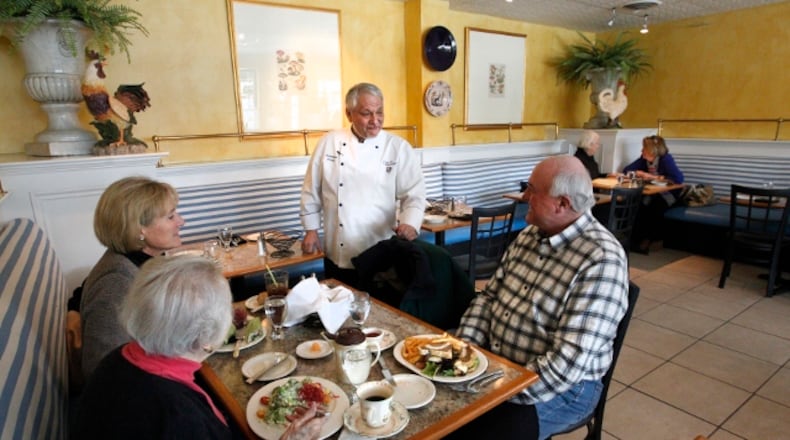 Dominique Fortin, owner of Dominique’s Bistro & Bar, talks with diners during Restaurant Week in January 2014. The restaurant, which opened in 2003, shut down at the close of business on Saturday, July 18. LISA POWELL/STAFF