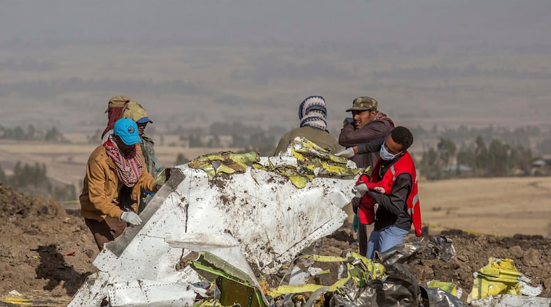 FILE - In this March 11, 2019, file photo, rescuers work at the scene of an Ethiopian Airlines flight crash near Bishoftu, Ethiopia. Pilot Bernd Kai von Hoesslin pleaded with his bosses for more training on the Boeing Max, just weeks before the Ethiopian Airline's jet crashed, killing everyone on board. (AP Photo/Mulugeta Ayene, File)
