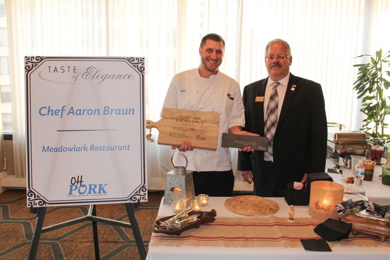 Aaron Braun, a chef at Meadowlark Restaurant won the top honors at the Ohio Pork Council’s  2019 Taste of Elegance Chef Competition and Legislative Reception in New Albany. He is pictured with  Ohio Pork Council President Dave Shoup.
