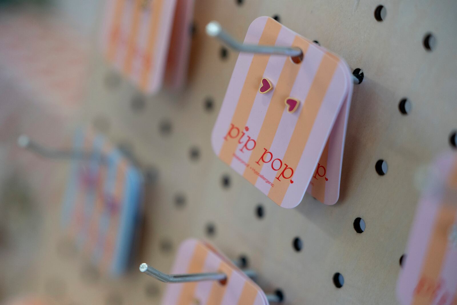 Earrings manufactured in China are displayed for sale at the baby store Three Littles' Union Market location in Washington, on Wednesday, April 16, 2025. (AP Photo/Nathan Howard)