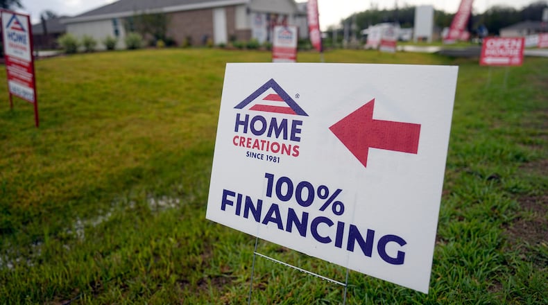 FILE - A sign promoting 100% financing is displayed outside a model home in the Colony Ridge development in Cleveland, Tx., Oct. 3, 2023. (AP Photo/David J. Phillip, File)