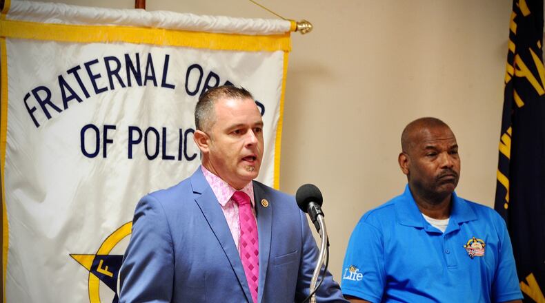 Kraig Robinson, president of Dayton Fire Fighters, Local 136, left, and Deric McDonald, vice president of Fraternal Order of Police Local 44, spoke to the media Thursday, Oct. 28, 2021, to address what they called a looming crisis Involving the city’s vaccine rules for workers. MARSHALL GORBY\STAFF