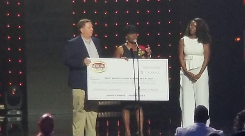 Trotwood Mayor Mary McDonald and attorney Jeff Rezabek, who is the Trotwood Disaster Relief chair, were presented a check of $10,000 from African Pride at Gospel Superfest last weekend. CONTRIBUTED