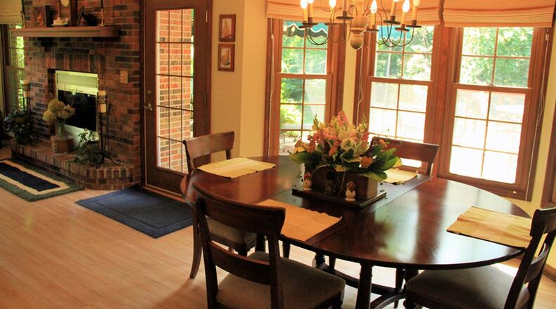 The open breakfast area sits in a 4-window bay area separated from the kitchen by a peninsular counter, which makes up part of the U-shaped workspace.