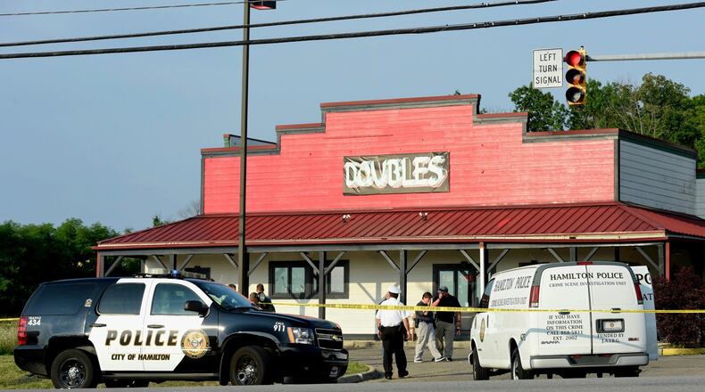 This was the scene after a 2 a.m. July 24 at Doubles Bar shooting on Main Street in Hamilton left one person dead and others wounded. Hamilton police investigated and collected evidence well into the morning. NICK GRAHAM/STAFF