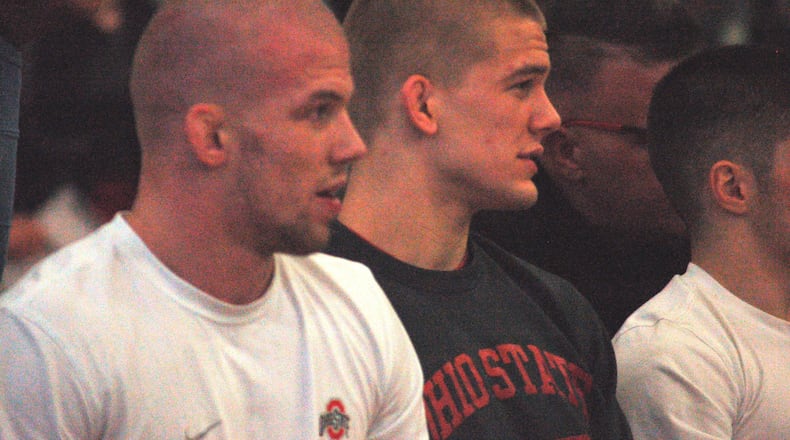 Ohio State’s Bo and Micah Jordan watch one of their teammates during Ohio State’s dual with Purdue Sunday at Graham High School. John Cummings/CONTRIBUTED
