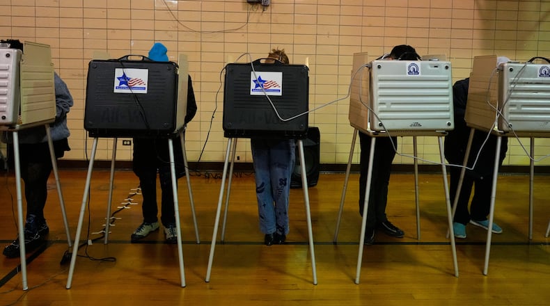 Democratic candidate for Congress, Kat Abughazaleh, center, casts her vote in a primary election for the upcoming midterms, in Chicago, Tuesday, March 17, 2026. (AP Photo/Nam Y. Huh)