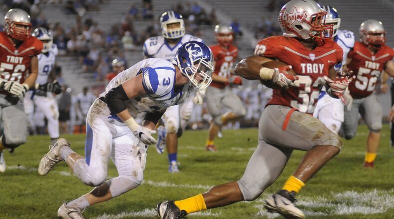 Troyâs Josh Brower (with ball) eludes Miamisburgâs Chris Meyers. Miamisburg defeated Troy 21-17 in a Week 5 high school football GWOC crossover game at Troyâs Memorial Stadium on Friday, Sept. 23, 2016. MARC PENDLETON / STAFF