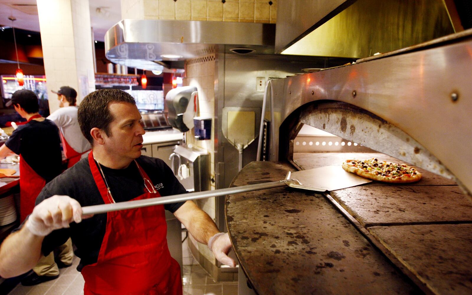 Owner Glen Brailey of Spinoza's Pizza prepares pizza dough at the restaurant inside the Mall at Fairfield Commons.