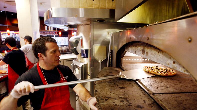 Owner Glen Brailey of Spinoza's Pizza prepares pizza dough at the restaurant inside the Mall at Fairfield Commons.