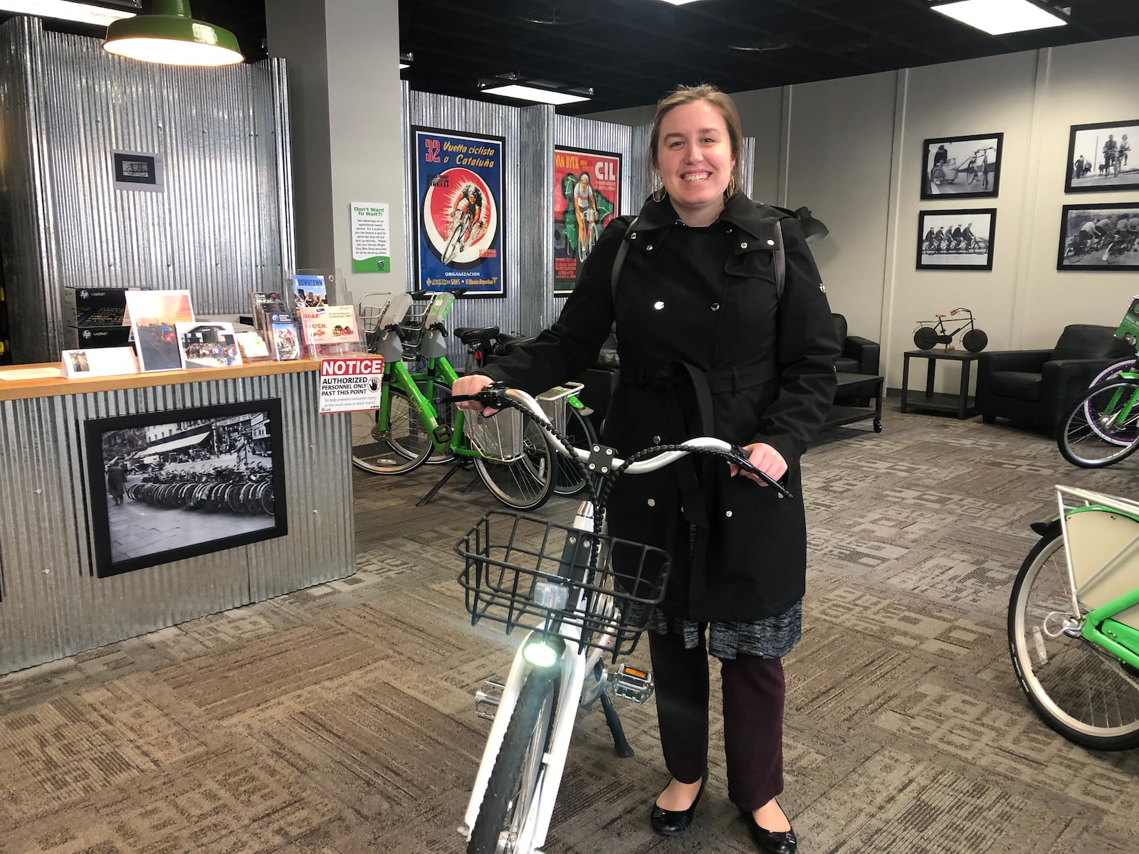 Laura Estandia, executive director of Bike Miami Valley, shows off one of Link Dayton Bike Share’s new electric bikes. CORNELIUS FROLIK / STAFF