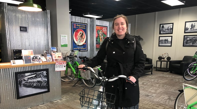 Laura Estandia, executive director of Bike Miami Valley, shows off one of Link Dayton Bike Share’s new electric bikes. eLink, the new electric-assisted bikes, will debut this spring. CORNELIUS FROLIK / STAFF