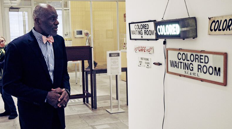 In this Jan. 11, 2018 photo, Alan Page, NFL Hall of Famer and retired Minnesota Supreme Court justice, looks at a display which is among the artifacts of slavery and segregation collected by Page and his wife, Diane Sims Page. They went on display at the Minneapolis Central Library this month in time for Super Bowl visitors and thousands of other people expected to flock to downtown for the festivities. (AP Photo/Steve Karnowski)
