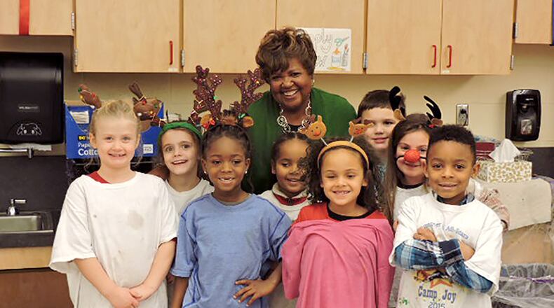 State board of education member Charlotte McGuire poses with students during a visit to Northmont City Schools. FILE PHOTO