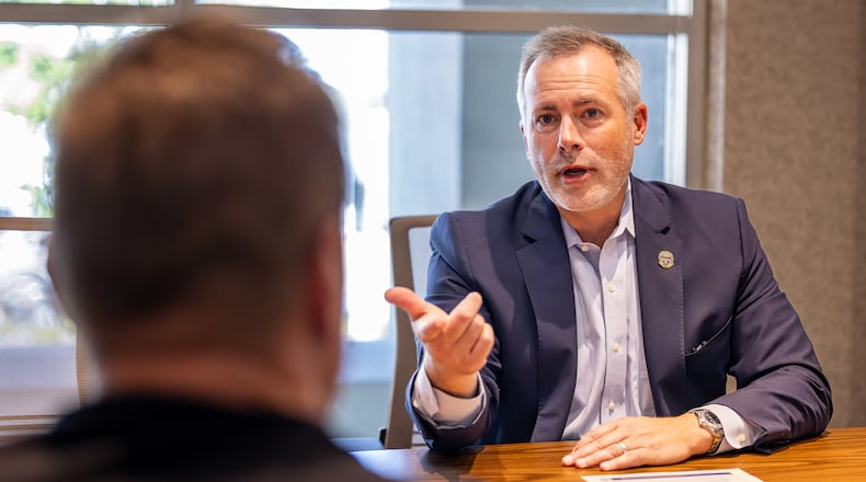 Ohio Treasurer Robert Sprague (right) talks with local business owner A.J. Rolling during a meeting at Dayton Region Manufacturers Association's office in downtown Dayton on Monday, Oct. 6. Sprague is promoting the Buckeye Business Advantage program his office is launching. The program provides low interest loans up to $1 million at a rate 3 percent below current rates over two years for small companies. BRYANT BILLING/STAFF