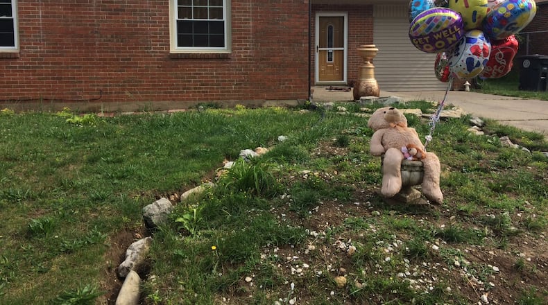 A makeshift memorial Friday for two children shot in their Dayton home included balloons and stuffed animals. STAFF