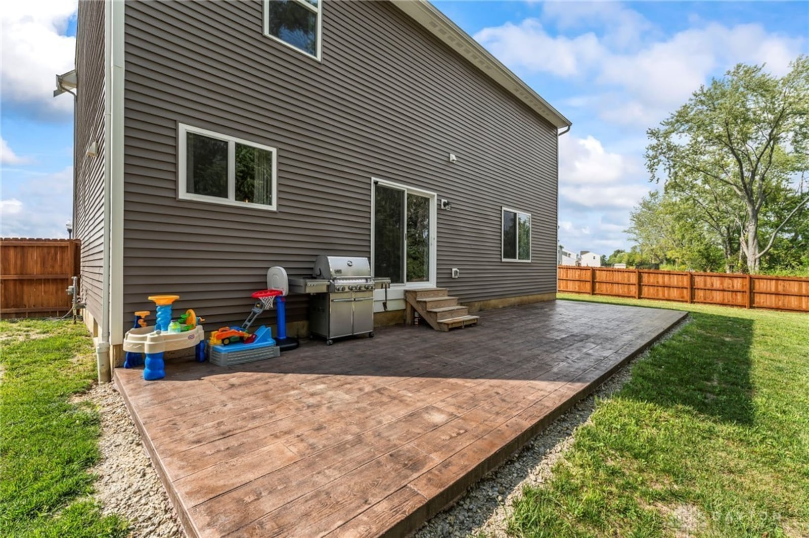 The back yard is fully fenced and features a stamped concrete patio. CONTRIBUTED