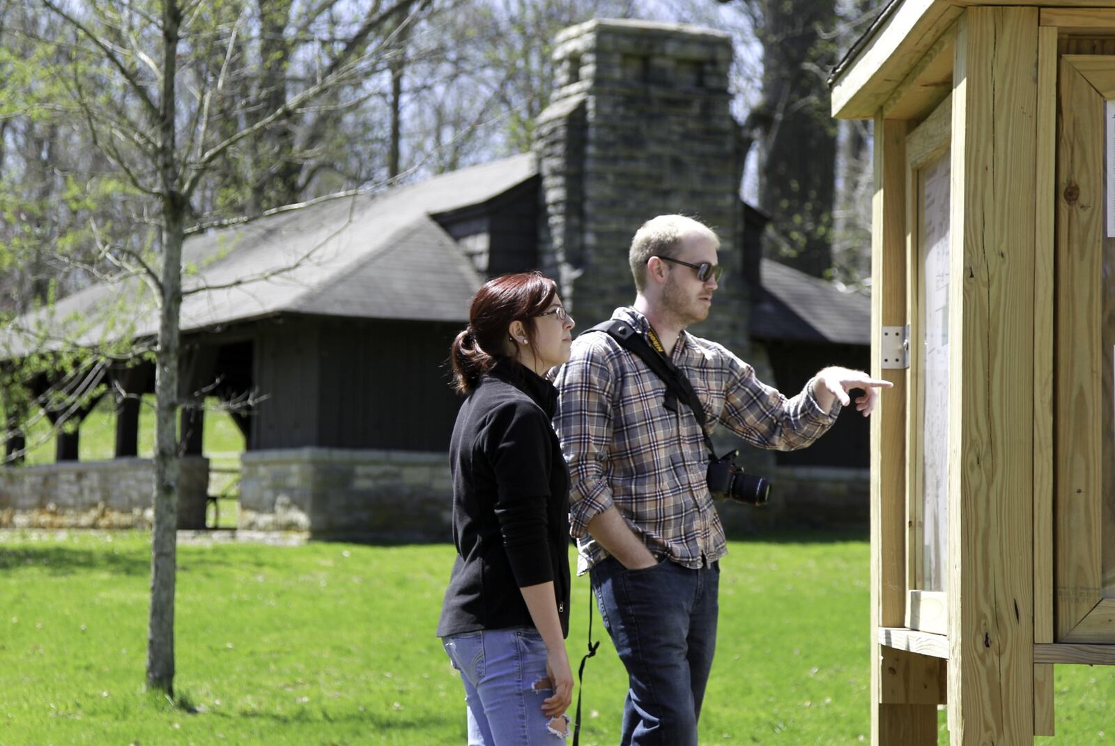 Emily Blair and Aaron Wheeler, both of Springfield, look at a map of John Bryan State Park while out for a hike on Wednesday, April 23. CHRIS STEWART / STAFF