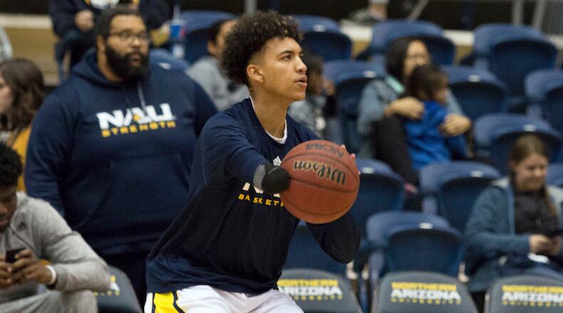 In this Jan. 18, 2018 photo provided by NAU Athletics, Northern Arizona's Omar Ndiaye warms up before an NCAA college basketball game against Eastern Washington in Flagstaff, Ariz. Ndiaye does not have a right hand due to a birth defect, but was still talented enough to become a Division I basketball player. (NAU Athletics vis AP)