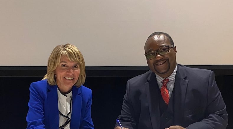 Janice Supplee, dean of graduate studies at Cedarville University, and F. Erik Brooks, provost and vice president for academic affairs, officially sign an agreement between Cedarville and Central State University giving Central State students preferred status in Cedarville health science graduate programs. Courtesy of Mark D. Weinstein, Cedarville University.