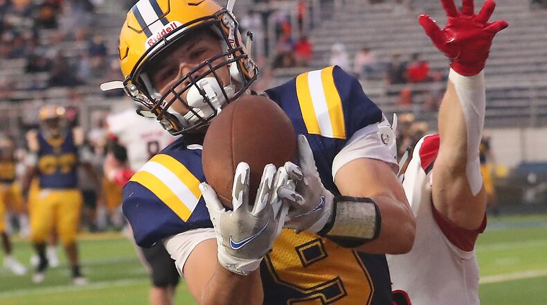 Springfield's Ben Van Noord catches a touchdown pass under pressure from Wayne's Kyle Johnson during Friday's season opener at Springfield. BILL LACKEY/STAFF