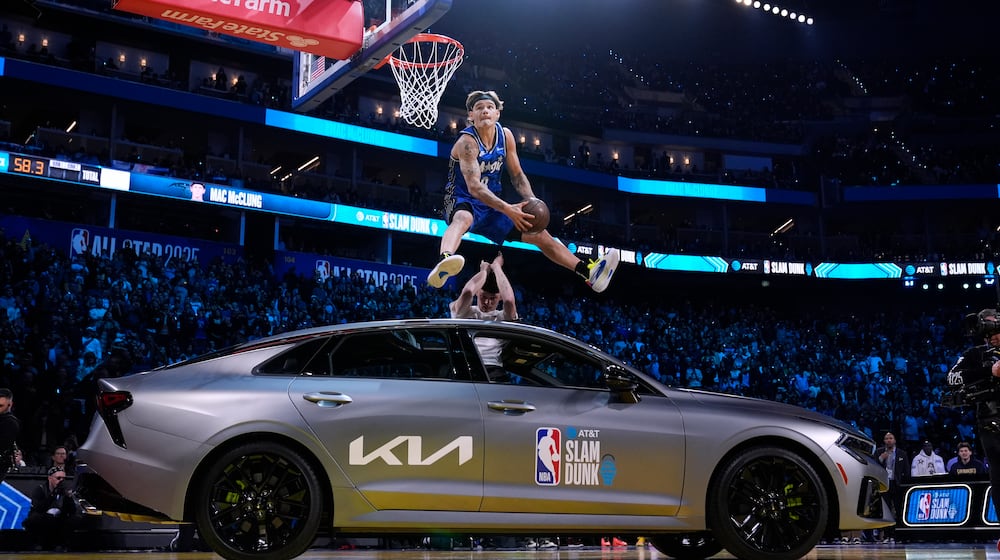 Osceola Magic guard Mac McClung dunks over a car during the slam dunk contest at the NBA basketball All-Star Saturday night festivities Saturday, Feb. 15, 2025, in San Francisco. (AP Photo/Godofredo A. Vásquez)