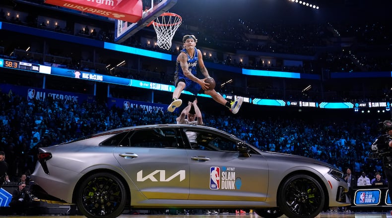 Osceola Magic guard Mac McClung dunks over a car during the slam dunk contest at the NBA basketball All-Star Saturday night festivities Saturday, Feb. 15, 2025, in San Francisco. (AP Photo/Godofredo A. Vásquez)