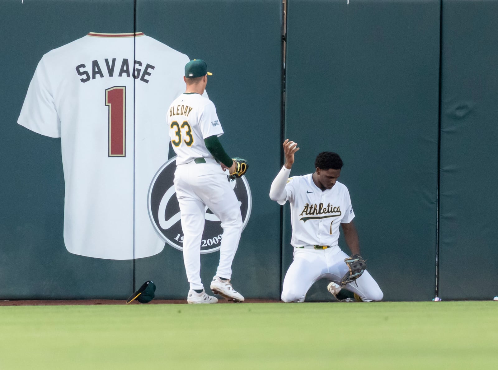 Athletics outfielder Denzel Clarke holds the ball up after colliding into the wall during the fourth inning of a baseball game against the Baltimore Orioles Friday, June 6, 2025, in West Sacramento, Calif. (AP Photo/Sara Nevis)