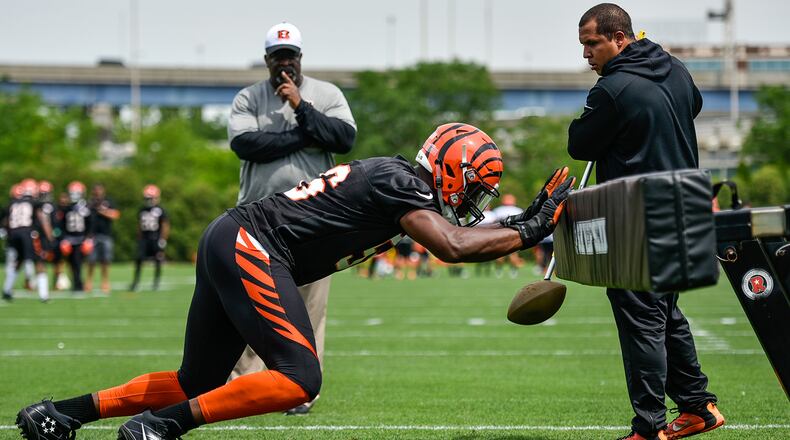 Cincinnati Bengals defensive end Carlos Dunlap hits a sled during off-season organized team activities Tuesday, May 31 at the practice fields near Paul Brown Stadium in Cincinnati. NICK GRAHAM/STAFF