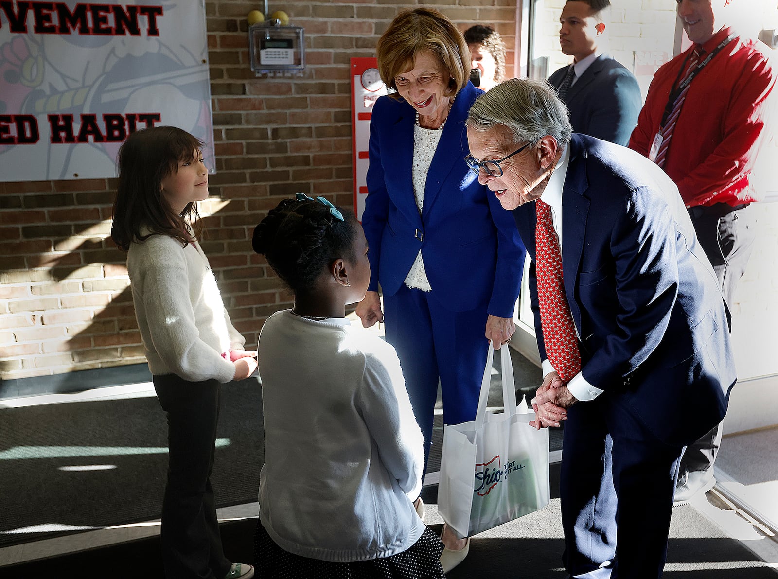 Ohio Governor Mike DeWine and wife Fran were greeted Monday, March 24, 2025 by Harold Schnell Elementary School students Ev Cooper, left, and Blake Glover in West Carrollton. The visit was part of a new effort to recognize Ohio schools that are raising literacy achievement as they become aligned with the Science of Reading. MARSHALL GORBY\STAFF

