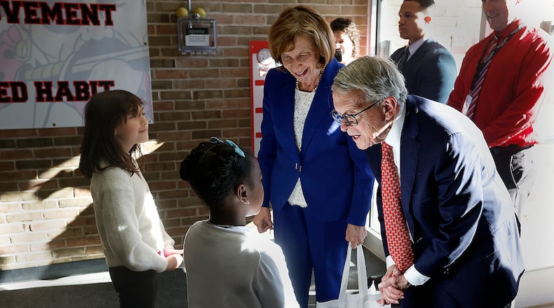 Ohio Governor Mike DeWine and wife Fran were greeted Monday, March 24, 2025 by Harold Schnell Elementary School students Ev Cooper, left, and Blake Glover in West Carrollton. The visit was part of a new effort to recognize Ohio schools that are raising literacy achievement as they become aligned with the Science of Reading. MARSHALL GORBY\STAFF