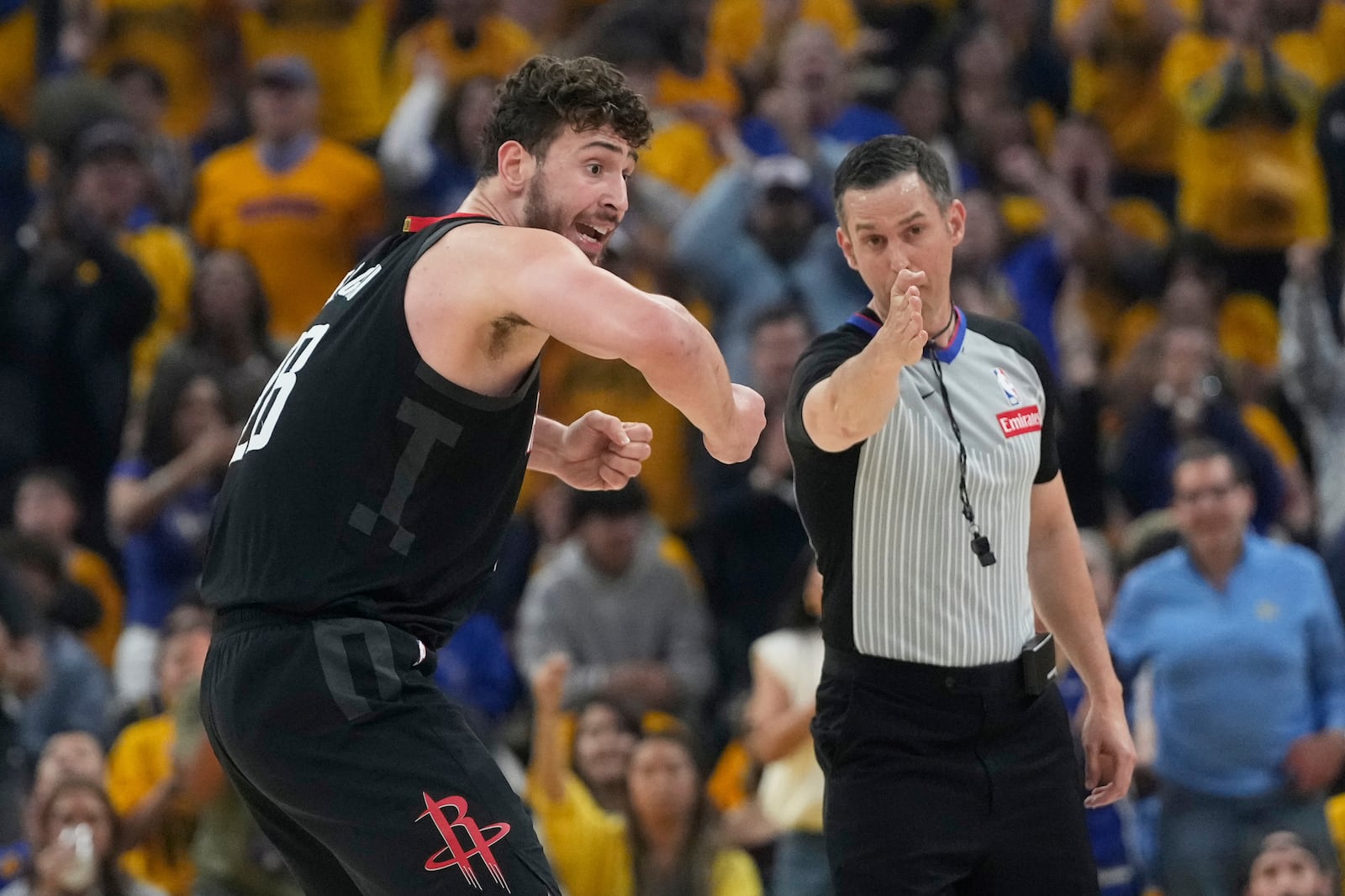 Houston Rockets center Alperen Sengun, left, reacts toward an official during the first half of Game 3 of an NBA basketball first-round playoff series against the Golden State Warriors in San Francisco, Saturday, April 26, 2025. (AP Photo/Jeff Chiu)