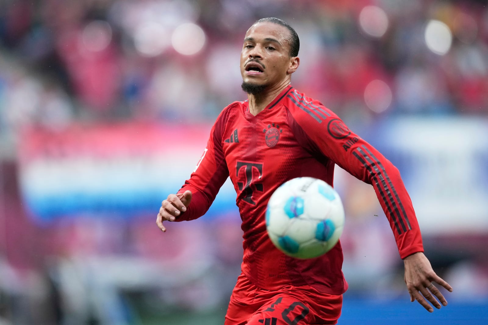 Bayern's Leroy Sane controls the ball during the German Bundesliga soccer match between RB Leipzig and FC Bayern Munich at the Red Bull Arena in Leipzig, Germany, Saturday, May 3, 2025. (AP Photo/Ebrahim Noroozi)