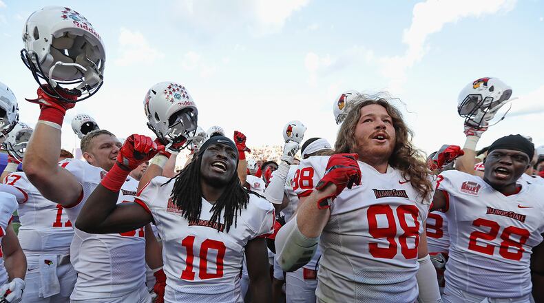 EVANSTON, IL - SEPTEMBER 10: (L-R) Bryce Holm #31, Davontae Harris #10 and Dalton Keene #98 and Kyle Williams #28 of the Illinois State Redbirds celebrate after a win against the Northwestern Wildcats at Ryan Field on September 10, 2016 in Evanston, Illinois. Illiinois State defeated Northwestern 9-7. (Photo by Jonathan Daniel/Getty Images)