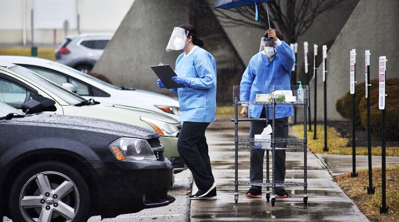 DNA Diagnostics Center staff do rapid COVID-19 testing in Fairfield, with results delivered to people in their cars. NICK GRAHAM / STAFF