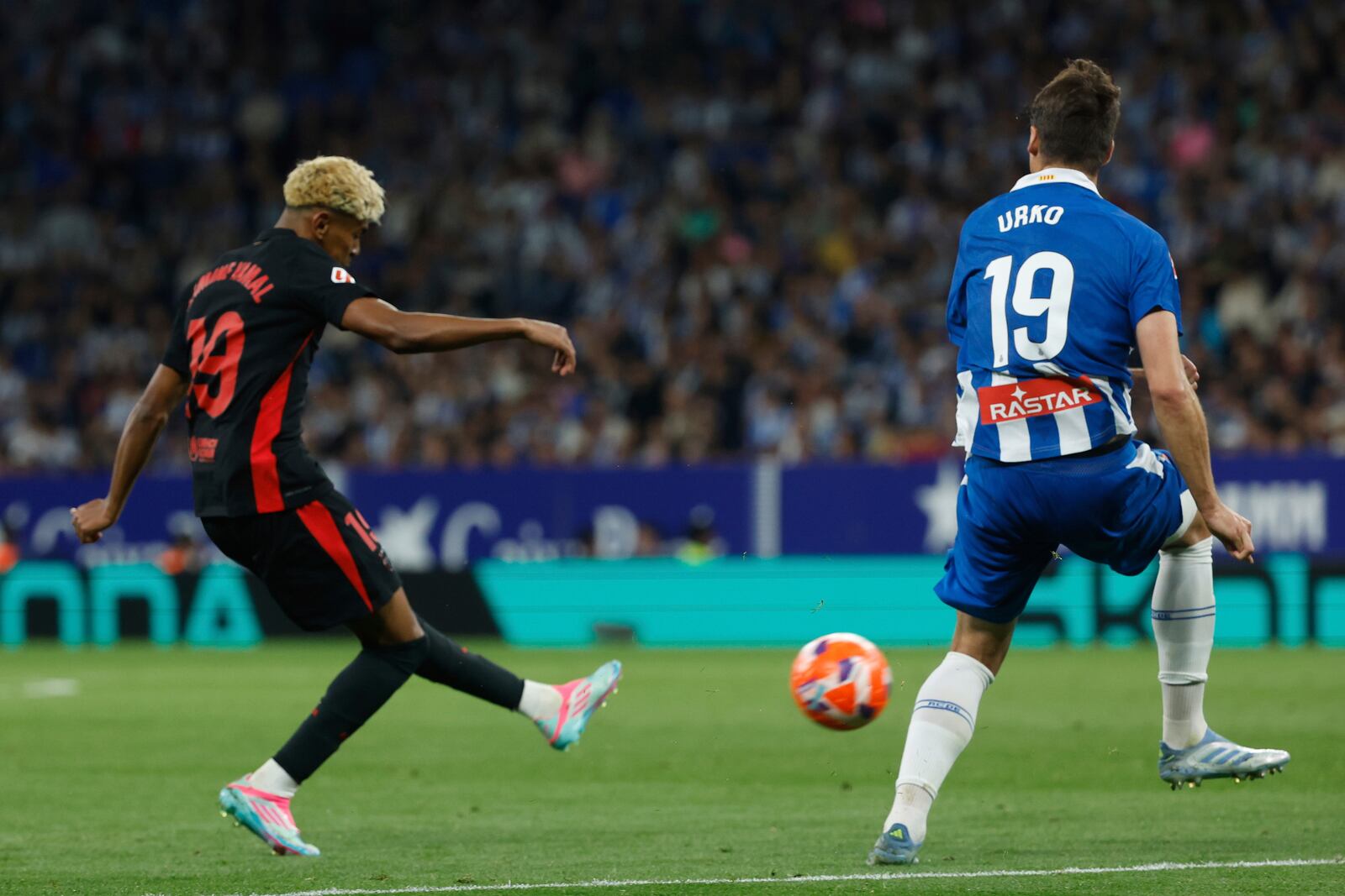 Barcelona's Lamine Yamal attempts a shot at goal to scores his side's opening goal during a Spanish La Liga soccer match between Barcelona and Espanyol at Lluis Companys Olympic Stadium in Barcelona, Spain, Thursday, May 15, 2025. (AP Photo/Joan Monfort)