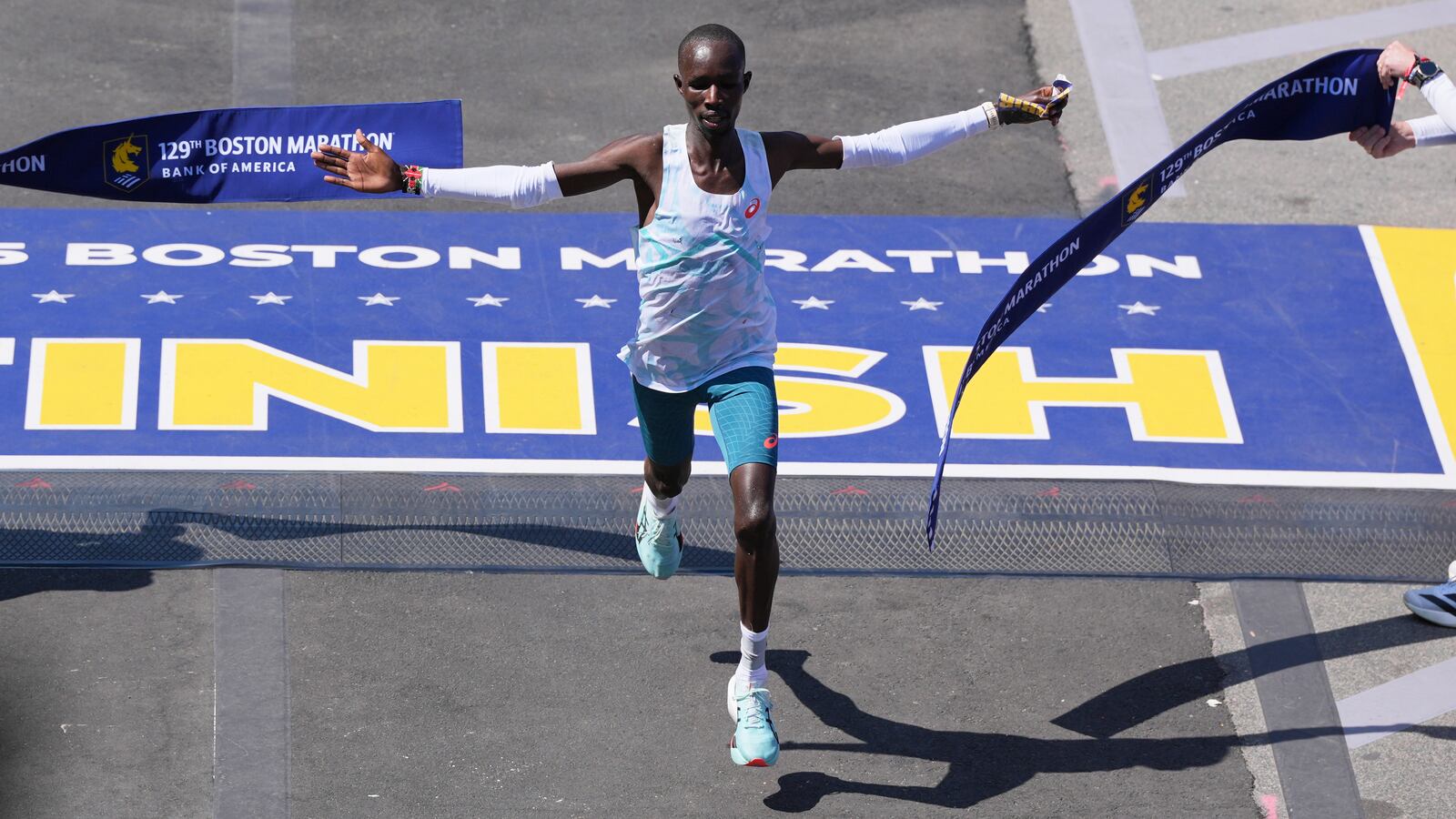 John Korir, of Kenya, breaks the tape to win the Boston Marathon, Monday, April 21, 2025, in Boston. (AP Photo/Charles Krupa)