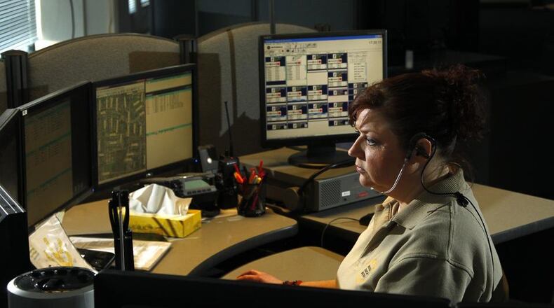 Civilian diispatcher Denise Steele works at the Montgomery County Regional Dispatch Center. Capt. Matt Haines, commander of the dispatch center, said strict training requirements and high turnover feed unavoidably steep overtime costs for his office. LISA POWELL / STAFF