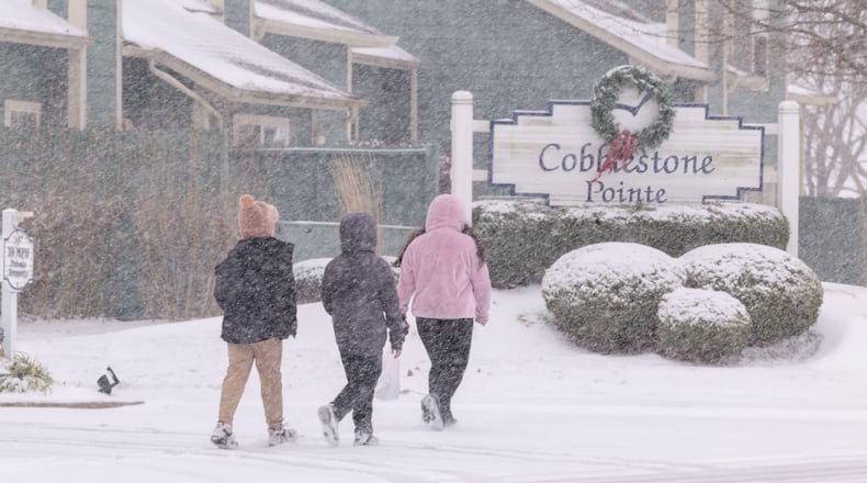 A group of children walk on South Stanfield Road in Troy on Saturday, Dec. 13, 2025. BRYANT BILLING/STAFF