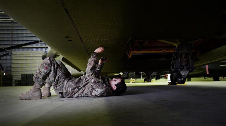U.S. Air Force 1st Lt. Kelli Walker, 1st Combat Aviation Brigade, battle damage materials scientist, photographs a U.S. Army CH-47 Chinook, Kandahar Air Field, Afghanistan, March 14, 2014. As a Joint Expeditionary Tasked (JET) battle damage scientist, Walker is primarily responsible for diagnosing all damage of unit aircraft, reporting recovery processes and providing scientific data to improve future aircraft restoration projects. (U.S. Air Force photo/Staff Sgt. Vernon Young Jr.)