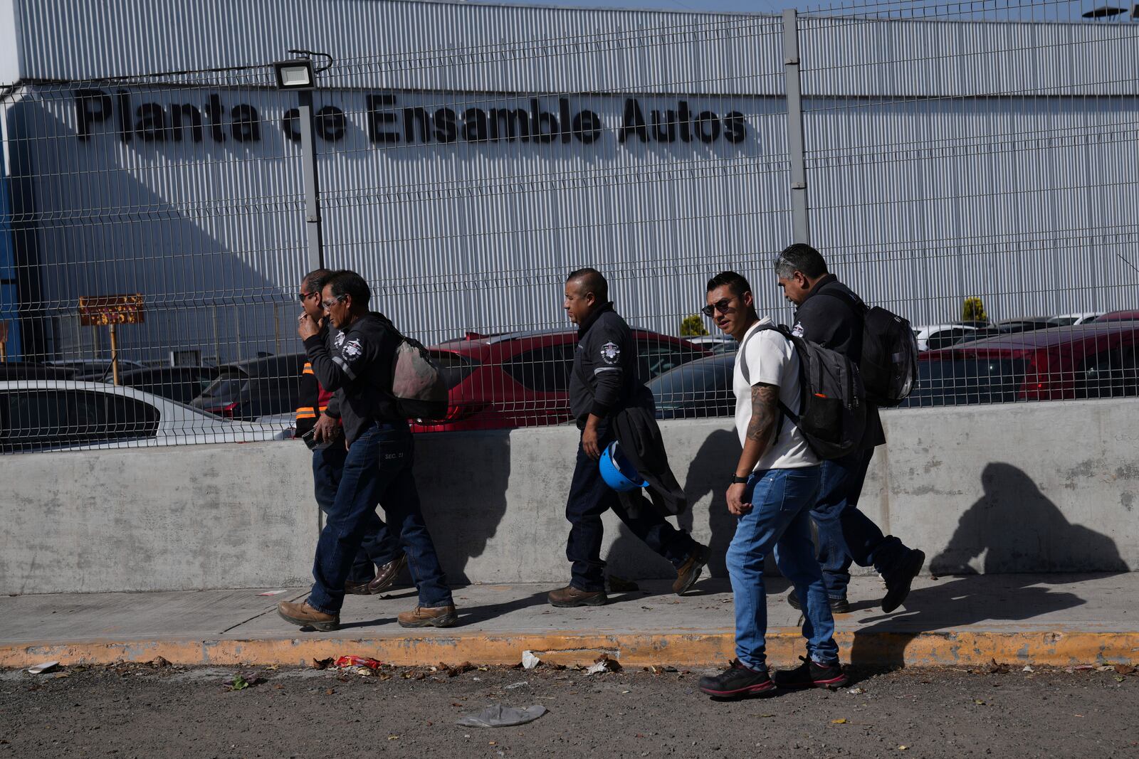 Workers arrive at the Stellantis car assembly plant in Toluca, Mexico, Thursday, April 3, 2025. (AP Photo/Marco Ugarte)
