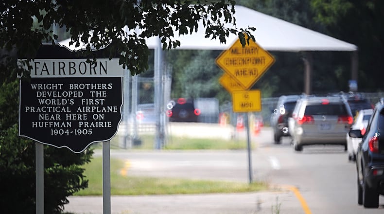 A historic marker in Fairborn denotes the efforts of the Wright Brothers in a photo take near a gate to Wright-Patterson Air Force Base. MARSHALL GORBY/STAFF